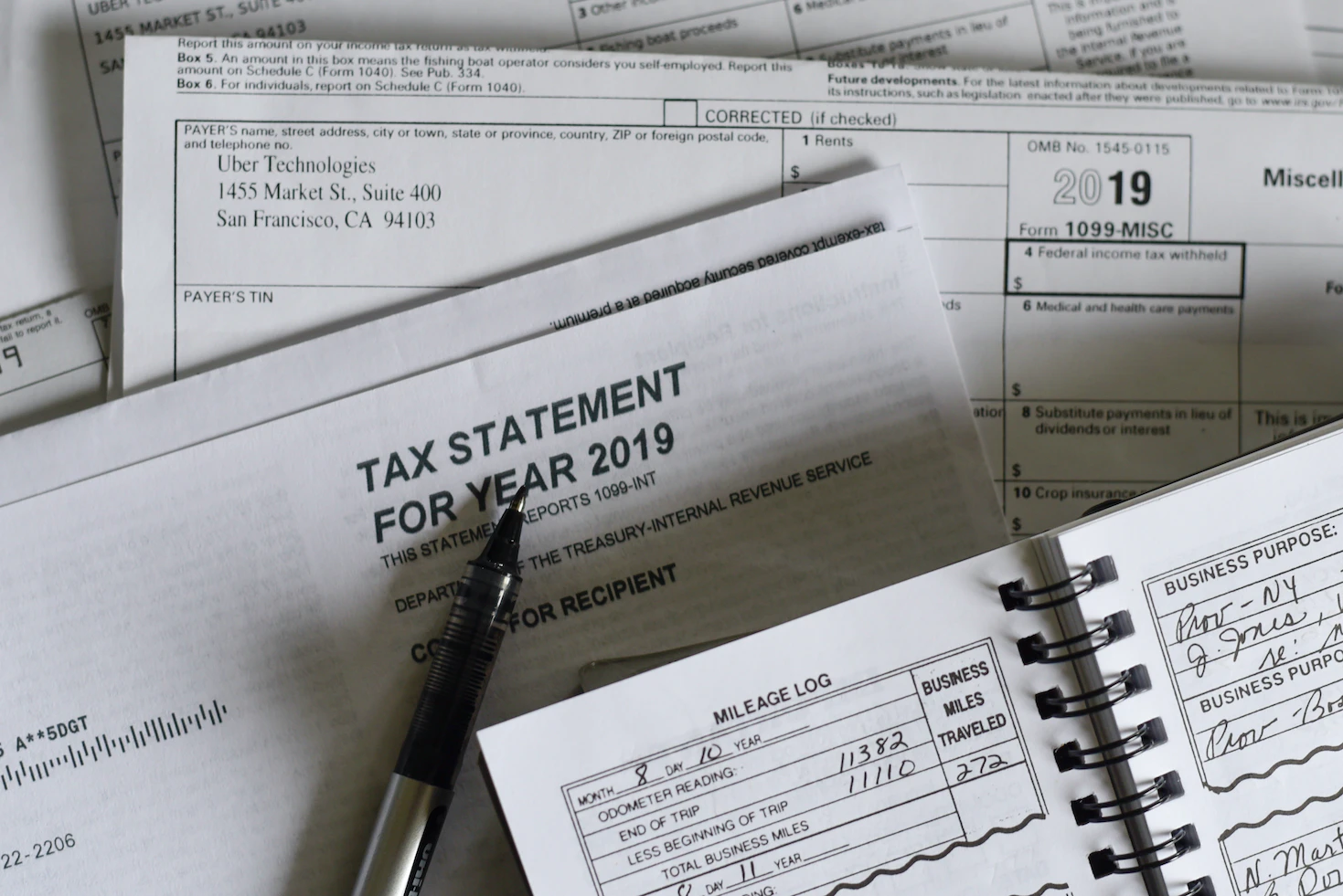 Steuererklärung Formulare, Rechnungen und ein Kugelschreiber.